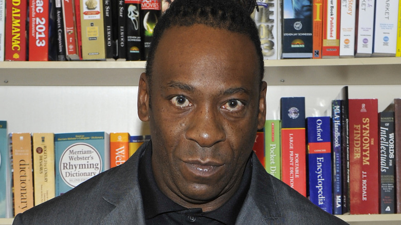 Booker T in front of a wall of books