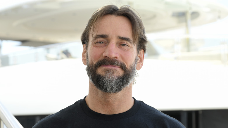 CM Punk poses for the camera on the red carpet before an event.