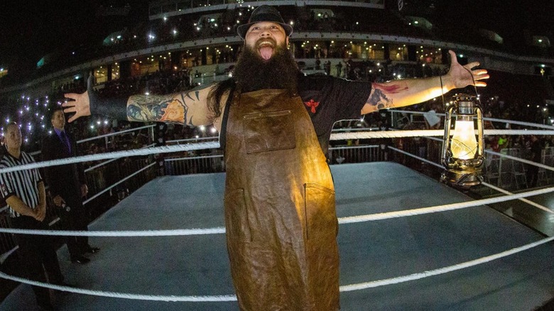 Windham Rotunda poses while entering a WWE ring for a match as his Bray Wyatt character.