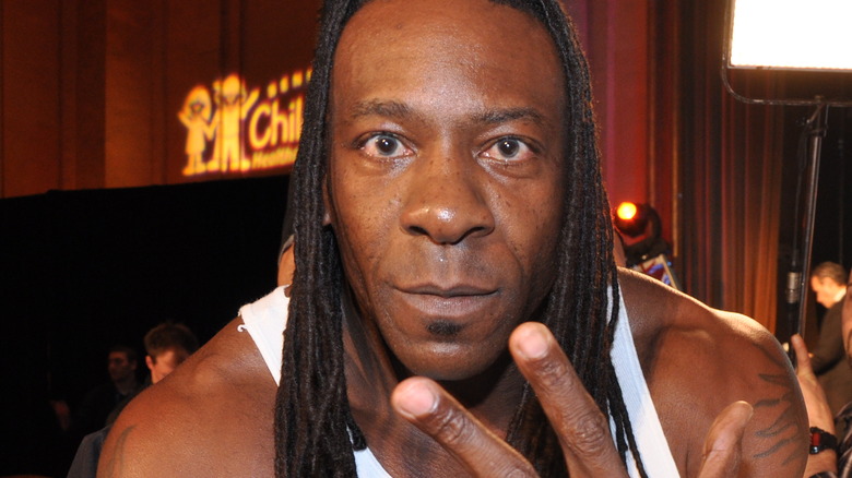 Booker T posing with the 5-time champion hand
