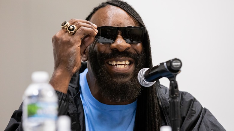 Booker T wearing black sunglasses and smiling
