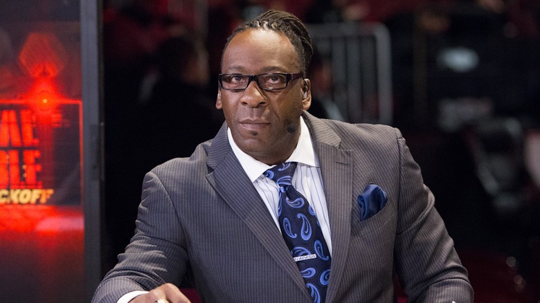 Booker T sits at panel desk