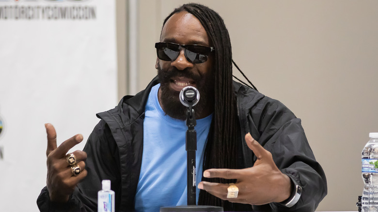 Booker T wearing sunglasses at a convention panel