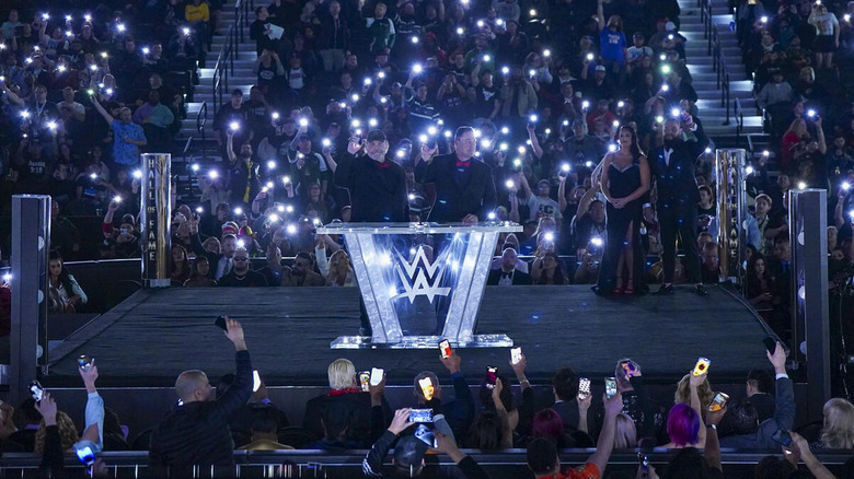 Mike Rotunda and Barry Windham, the father and uncle of Bray Wyatt, hold up their cell phones and get the fans to engage in a tribute to the late Wyatt at the 2024 Hall of Fame ceremony.