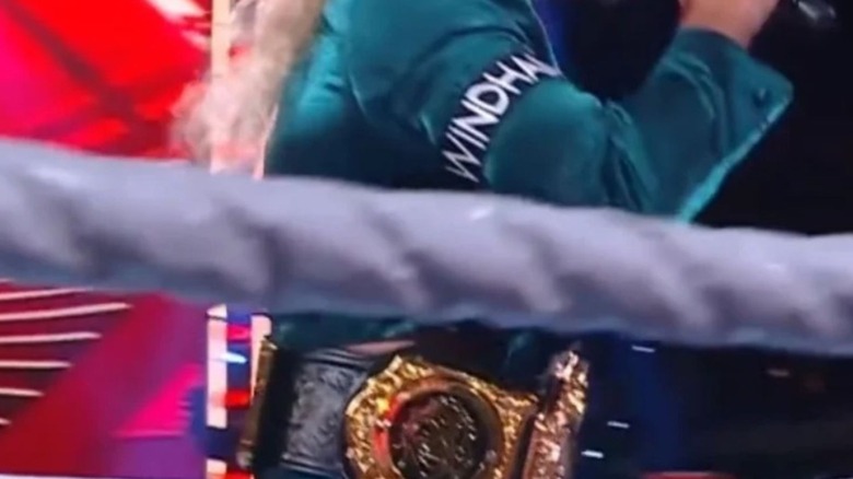 Seth Rollins cuts a promo in the ring while wearing the World Heavyweight Championship, complete with a side plate featuring The Fiend.