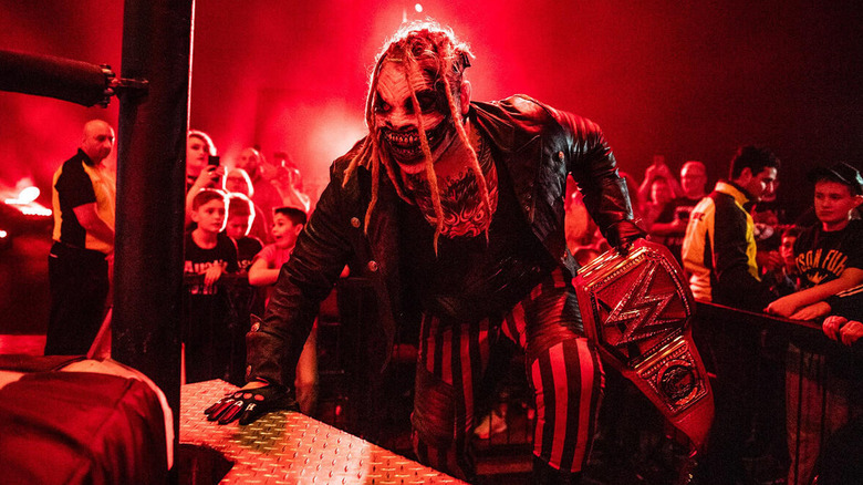 The Fiend makes his way up the stairs into the ring holding the WWE Championship.