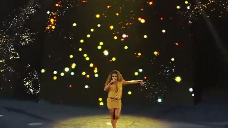 Bray Wyatt's widow, Jojo Offerman, performs at AEW All In onstage with "fireflies" behind her.