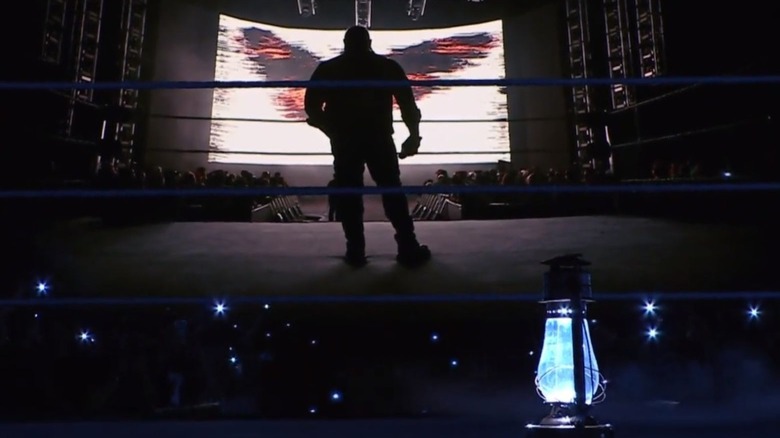 Bray Wyatt's lantern sits in the middle of the ring, in front of a graphic of the wrestler as the "WWE SmackDown" broadcast goes off the air.