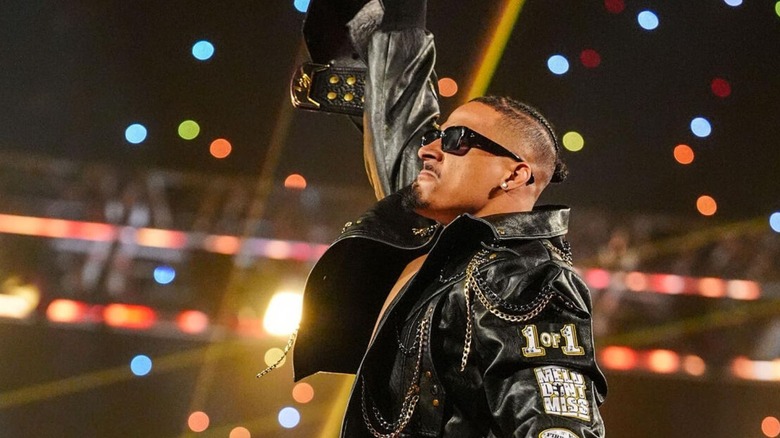Carmelo Hayes raises the United States Championship as he poses for the fans ahead of a match on "WWE SmackDown."