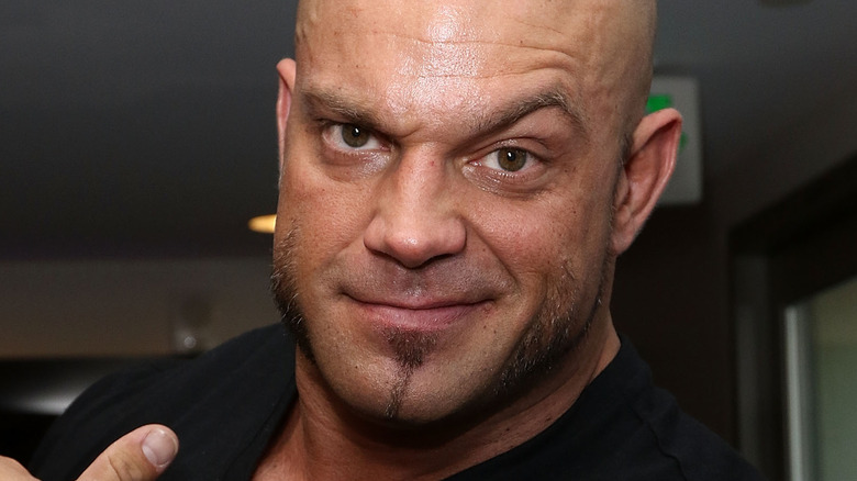 Brian Cage points to his raised eyebrow