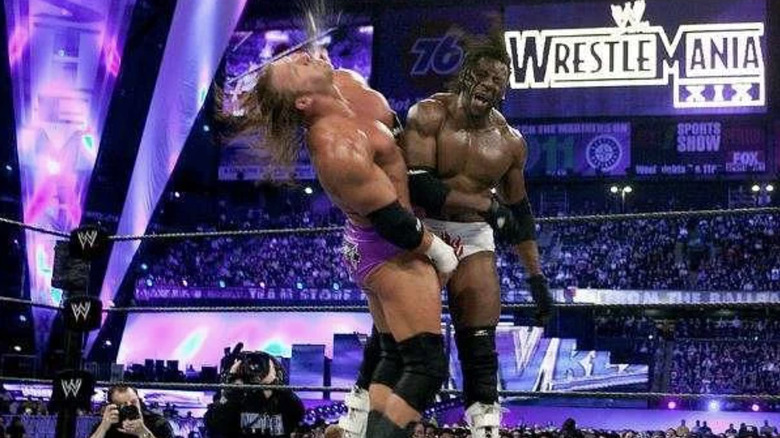 Booker hitting Triple H with a right hand