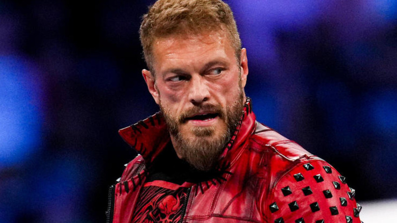 Edge wearing red leather jacket