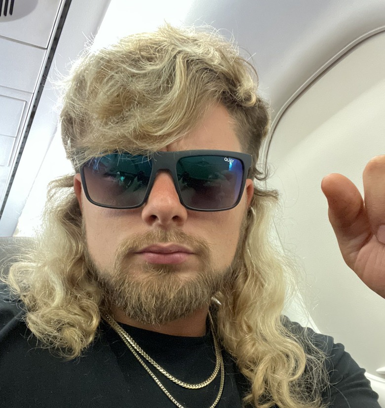 Brian Pillman Jr wearing sunglasses on an airplane