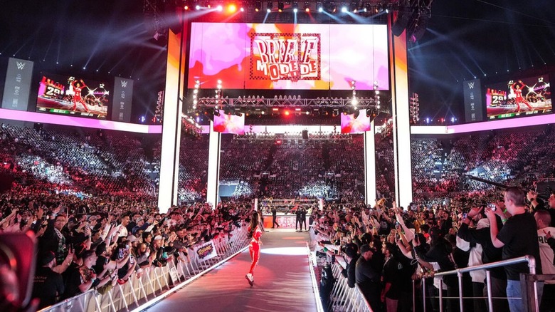 Brie Bella makes her way down the ramp to the ring, her "Brie Mode" tron video on display above the ring, during the 2026 Women's Royal Rumble.