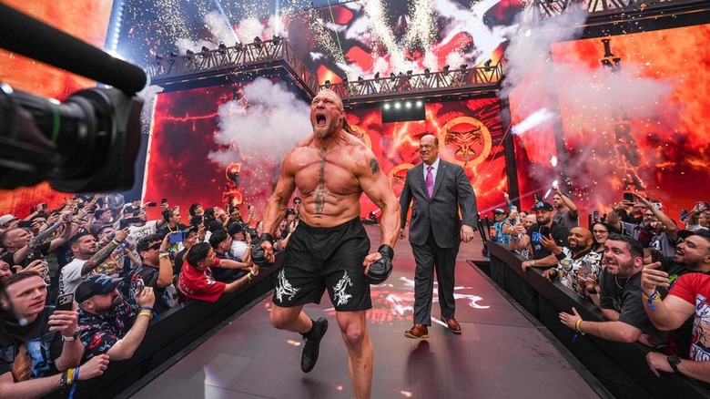 Brock Lesnar storms down to the ring at WWE WrestleMania 42, Paul Heyman behind him, before a match against Oba Femi.