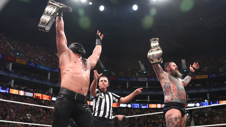 Bandido and Brody King hold up the AEW Tag Team Championships after winning the triple threat match at AEW x NJPW Forbidden Door.
