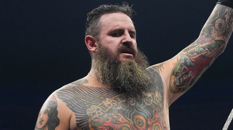 Brody King holding up his AEW World Tag Team Championship belt