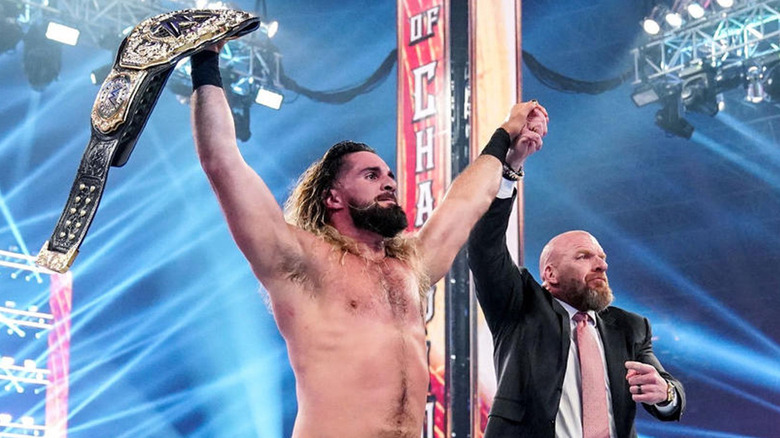 Seth Rollins with Triple H and the World Heavyweight title