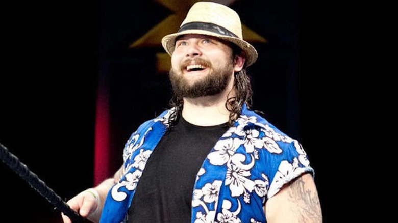 Bray Wyatt smiles on the ring apron