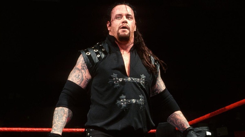 The Undertaker in ring with the World Tag Team Championships.