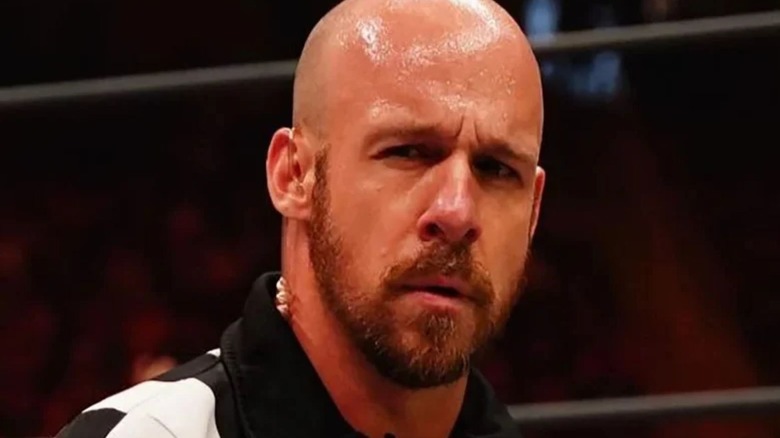 AEW referee Bryce Remsburg is picture with a confused look on his face during a match on an episode of AEW programming.