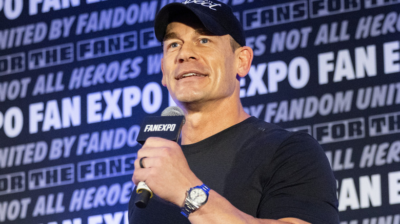 John Cena is holding a microphone