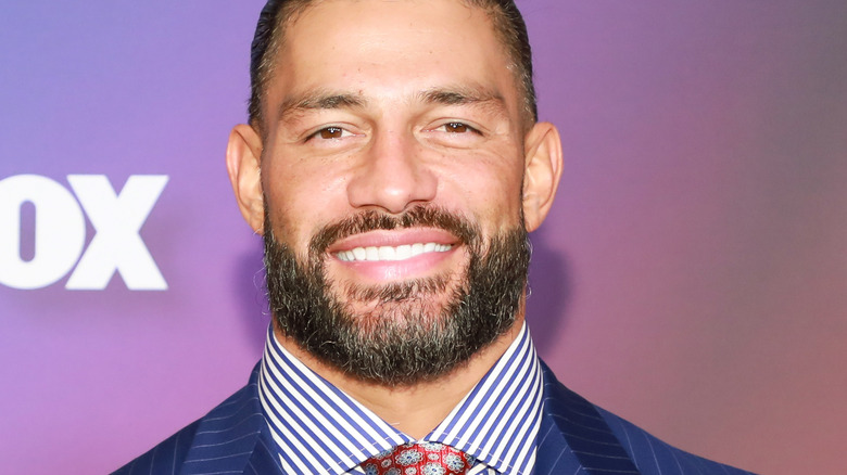 Roman Reigns smiles at a press event 
