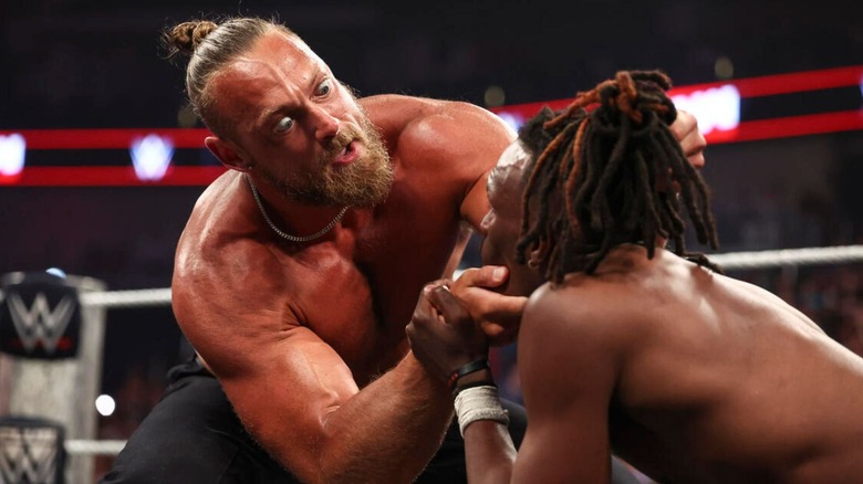 Big Cass holds Je'Von Evans face as he stares him down, following a beat down segment, where Cass return to the company, on 