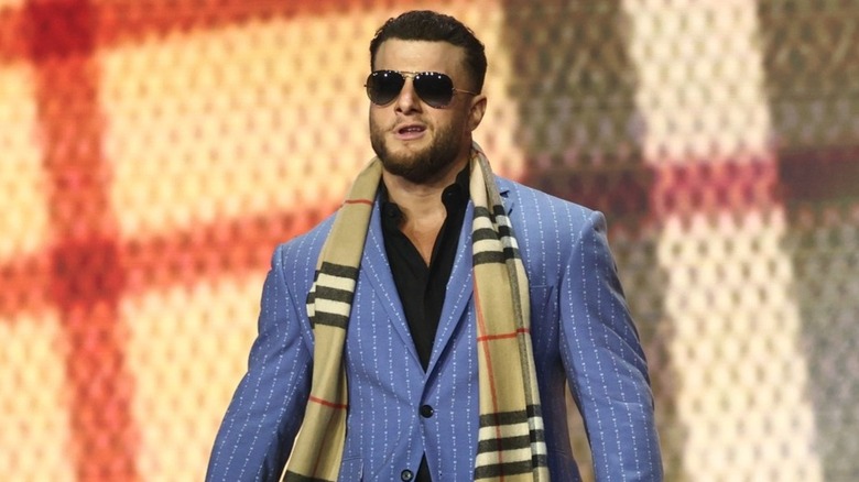 MJF makes his triumphant return to "AEW Dynamite" and stares down at the ring at Samoa Joe, "Hangman" Adam Page, and Swerve Strickland before making a speech