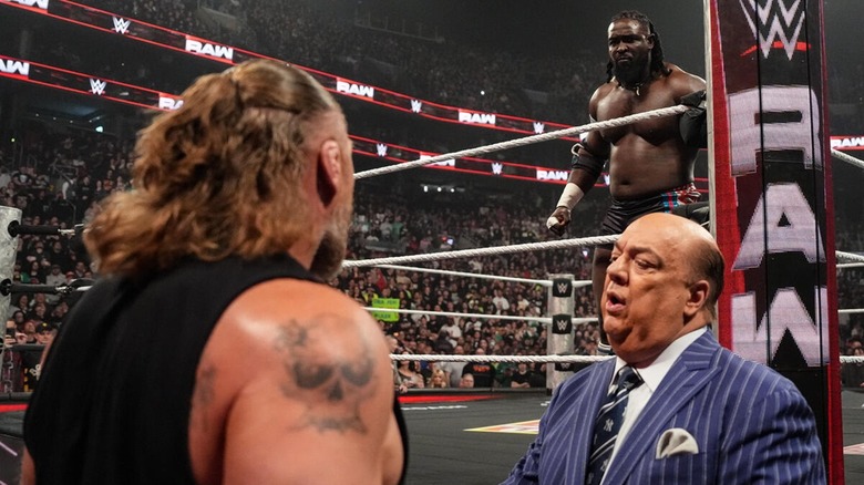 Brock Lesnar and Paul Heyman on the outside, Oba Femi in the ring