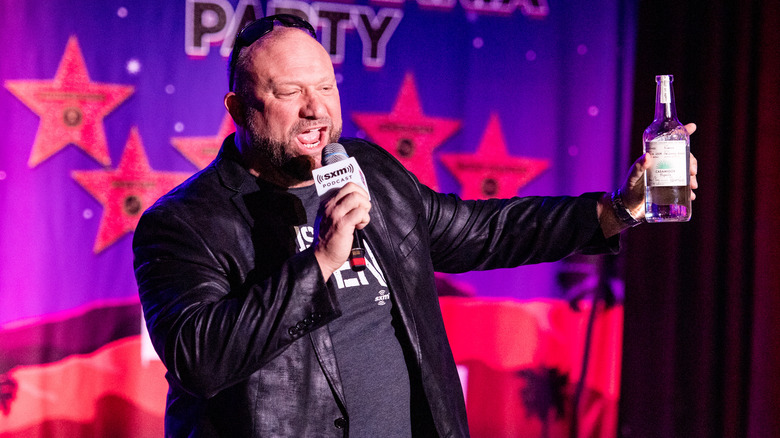 Bully Ray waves a bottle of tequila while speaking