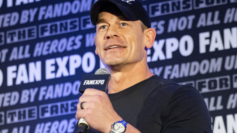 John Cena is holding a microphone