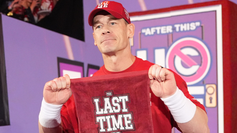 John Cena is holding up a red towel
