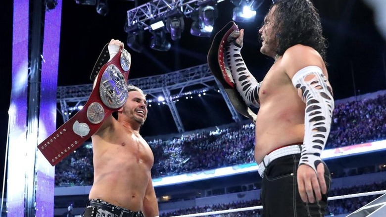 Matt and Jeff Hardy hold up the WWE Tag Team Championships in the ring following their ladder match victory at WrestleMania 33.
