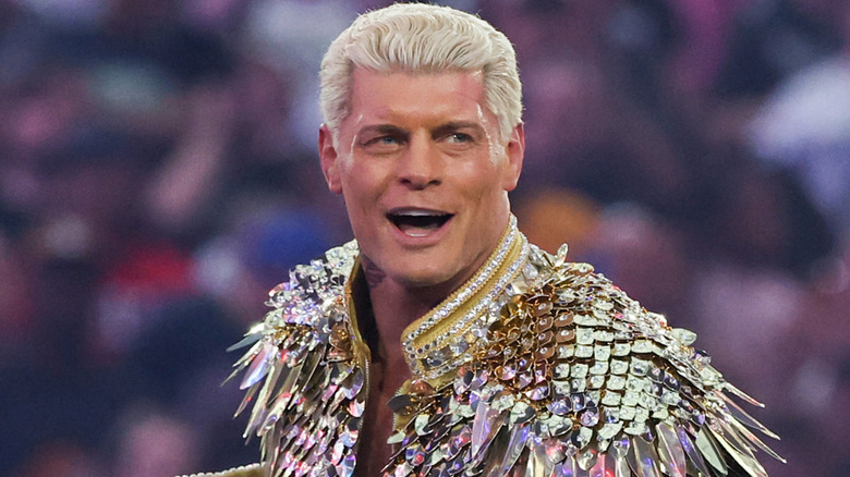 Cody Rhodes wearing a gold jacket