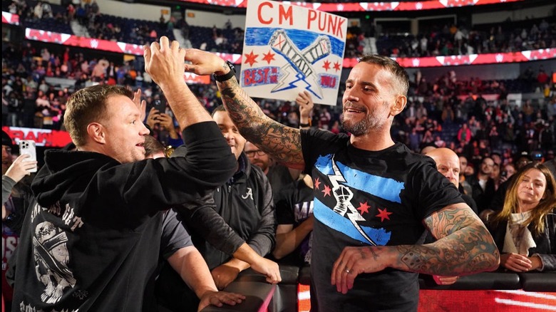 CM Punk high-fives a WWE fan