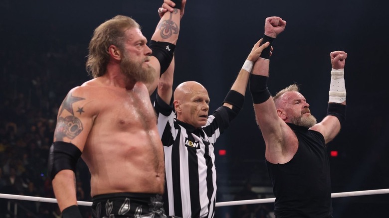 Adam Copeland and Christian Cage raising their arms
