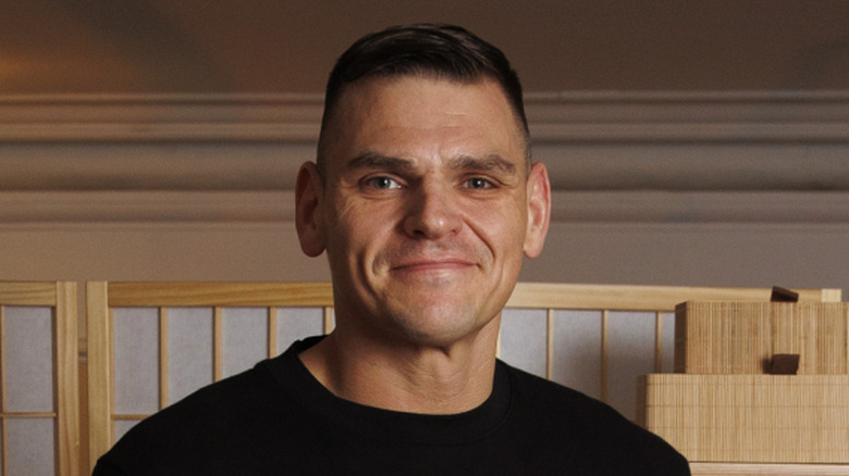 GUNTHER smiling in front of a shelf