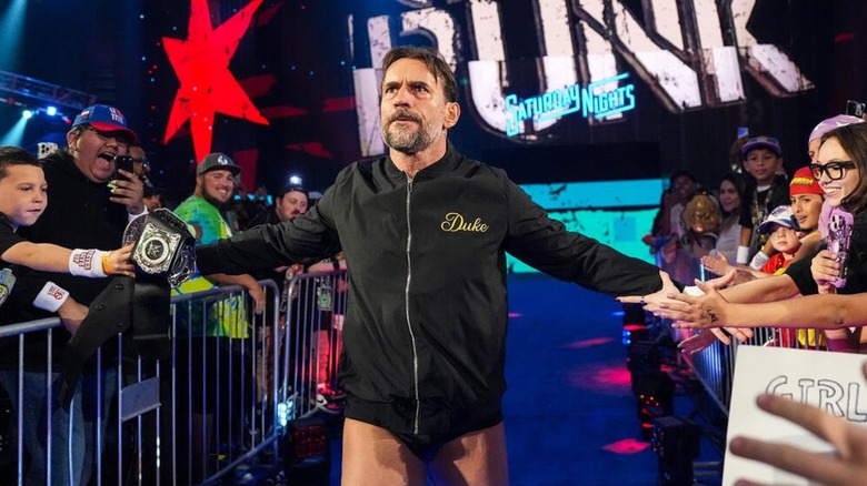 CM Punk heads down to the ring, high fiving fans, before his World Heavyweight Championship match with Jey Uso.
