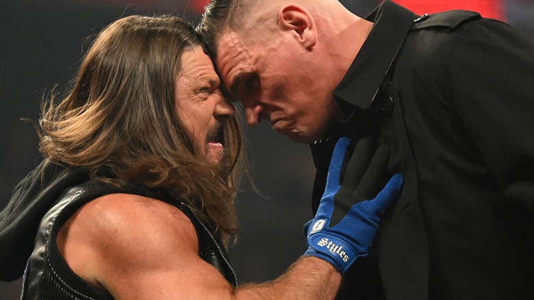 AJ Styles and Gunther pushing their fireheads against one another dujring their segment on 