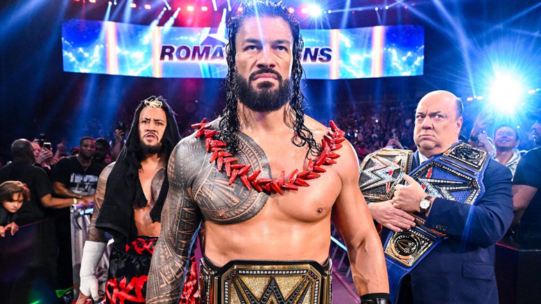 Solo Sikoa, Roman Reigns, and Paul Heyman staring ahead