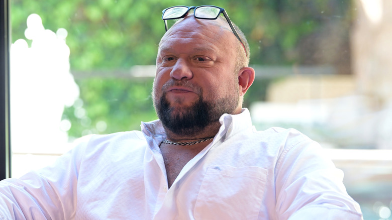 Bully Ray wearing a pink shirt with glasses on his forehead