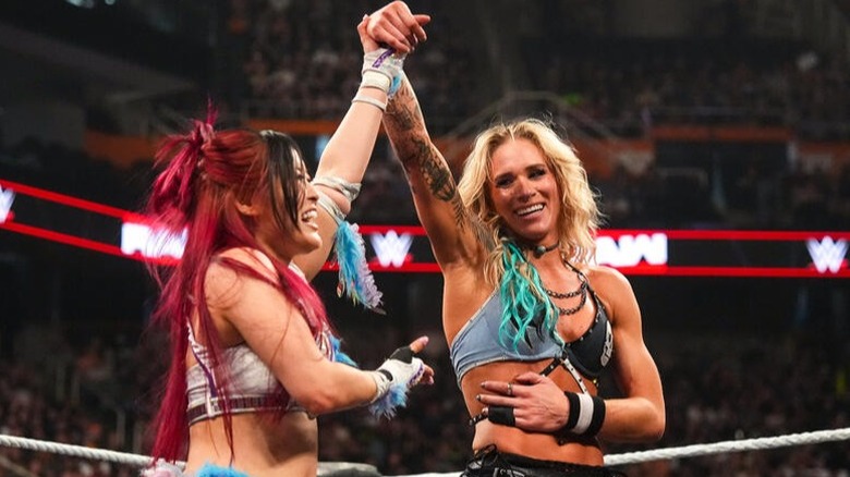IYO SKY raises Sol Ruca's hand to show her respect. SKY won their contest on the May 11 edition of "WWE Raw."