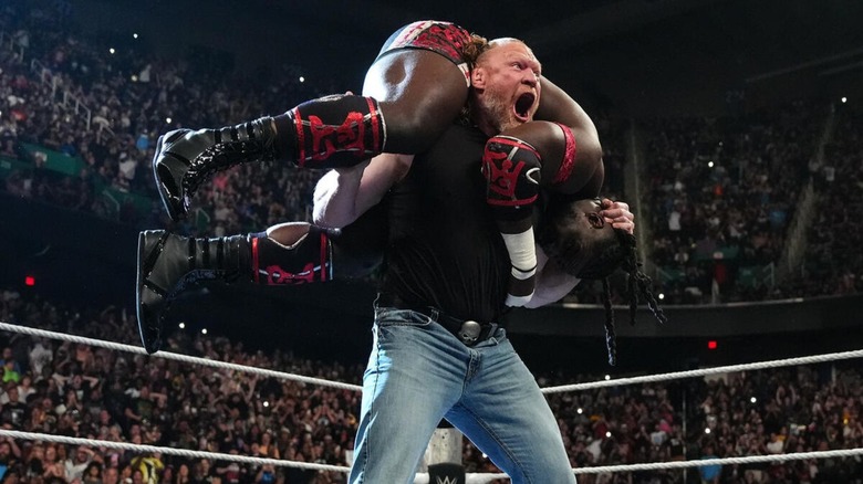 Brock Lesnar hoists Oba Femi up on his shoulders before hitting the F5 on an episode of 