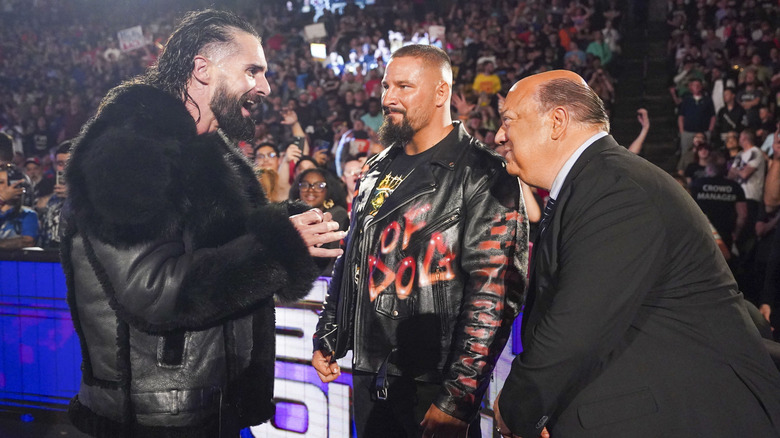 Seth Rollins, Bron Breakker, and Paul Heyman looking at each other