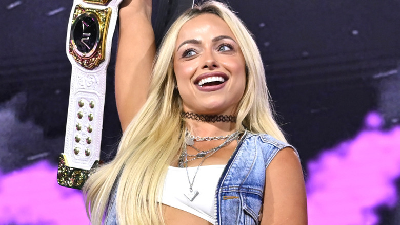 Liv Morgan holding up the WWE Women's World Championship
