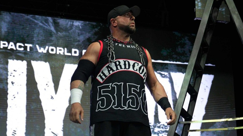 Bully Ray stands next to a ladder with a chain around his neck