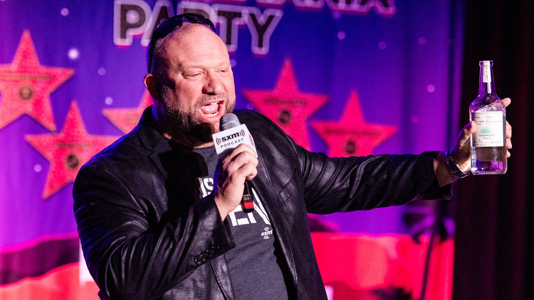 Bully Ray waves a bottle of tequila while speaking