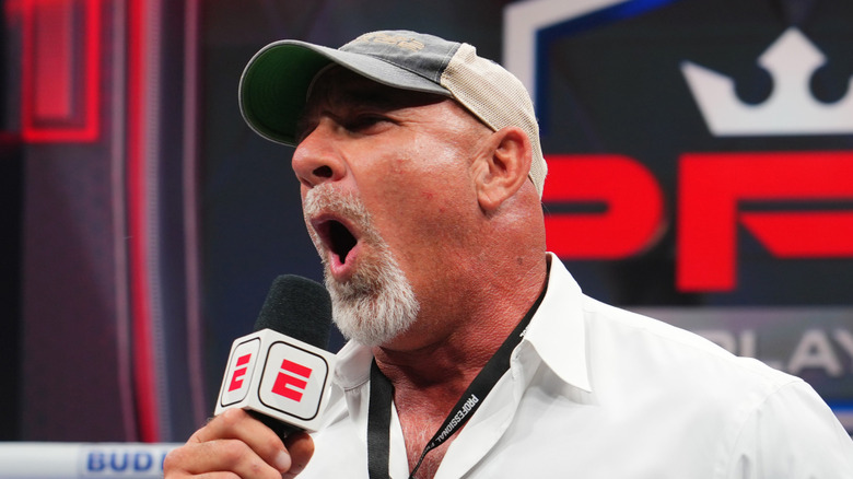 Goldberg shouting while wearing a hat