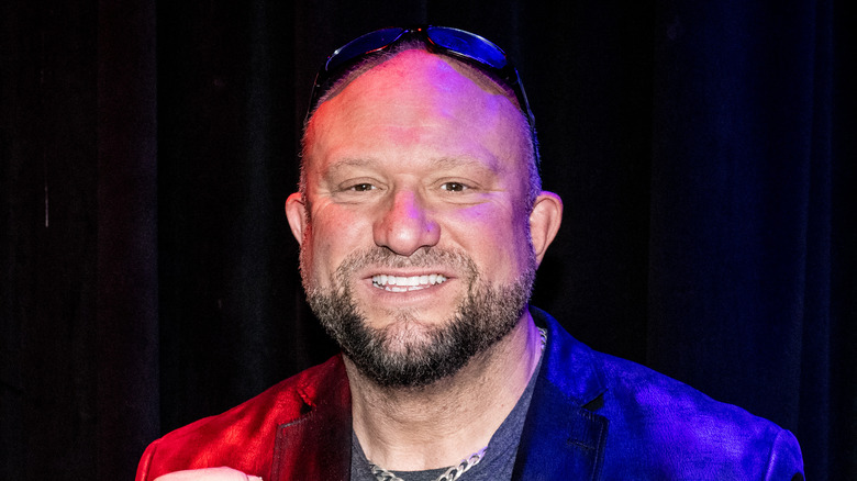 Bully Ray grins in front of a black curtain